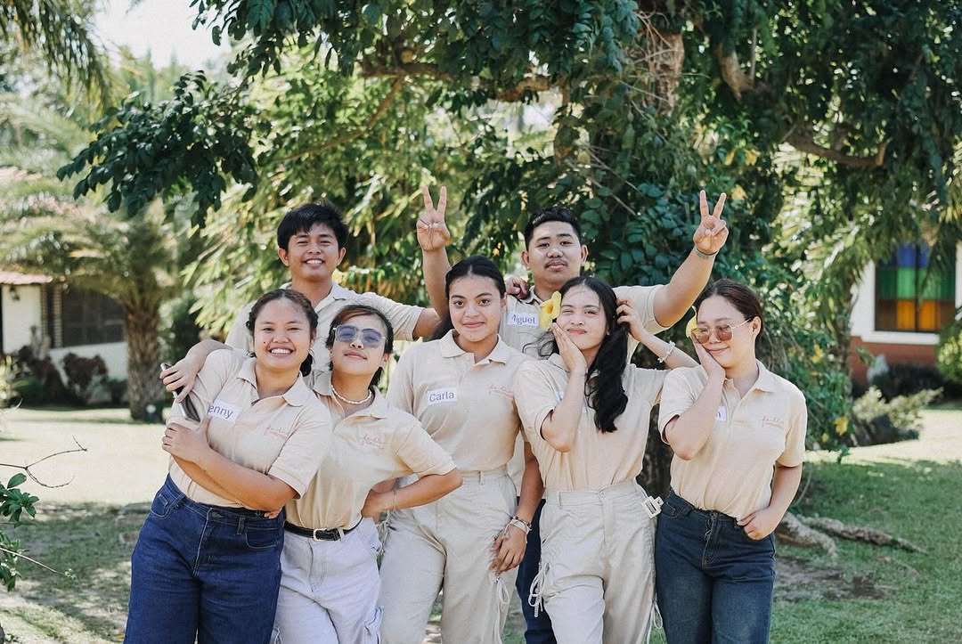 Fédici team members in uniform — small group smiling outdoors